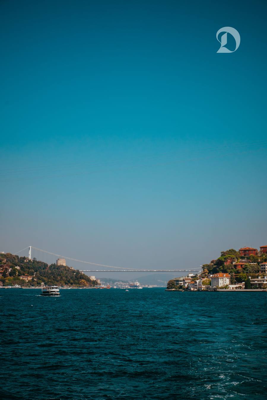 O priveliște impresionantă a strâmtorii Bosfor cu feribot și pod suspendat în Istanbul, Turcia